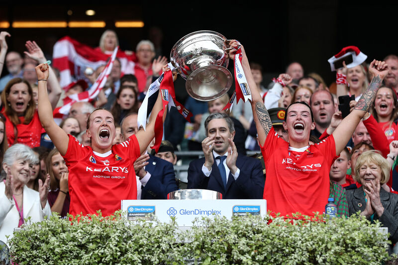 Cork's Laura Treacy and Ashling Thompson lift the Sean O’Duffy Cup after Cork's win over Galway in 2024. Picture: INPHO/Ben Brady