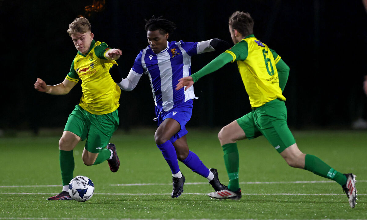  Destiny Okonkwo, College Corinthians, takes on Luke Hurley and James O'Connell, Rockmount. Picture: Jim Coughlan.
