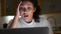 Unhappy Woman At Home With Computer Being Bullied Online On Social Media