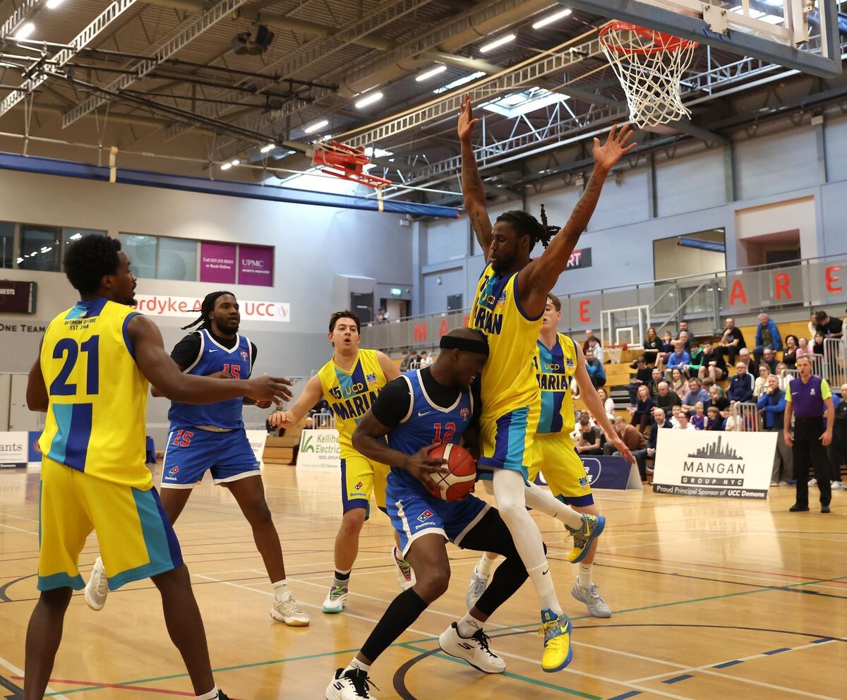  Tamyrik Fields, UCC Demons, takes on Zach Hinton, UCD Marian. Picture: Jim Coughlan.