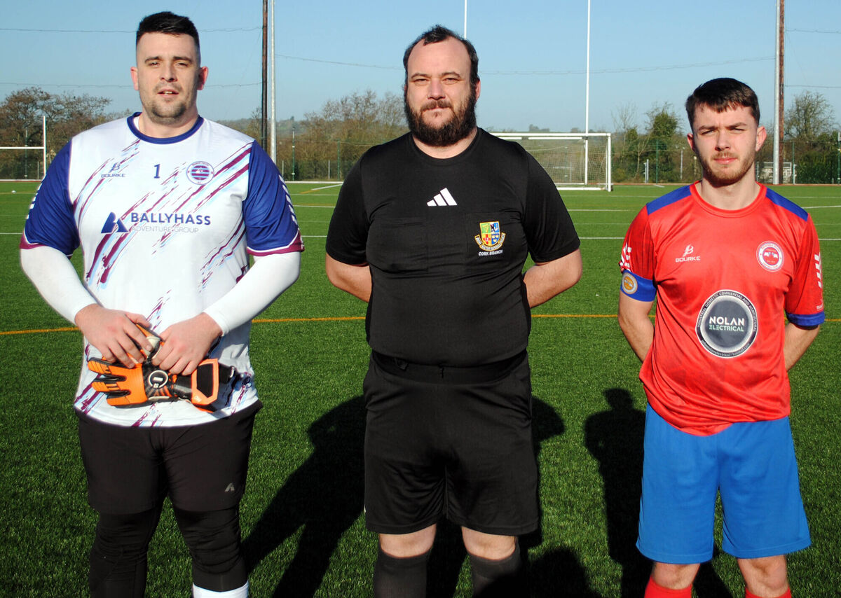 Rathcoole Rovers captain Leon Doody (right), with Boher Celtic's Darren Kiely, accompanied by referee Ken O'Driscoll. Picture: Barry Peelo.