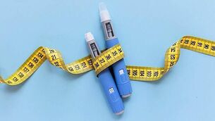 iStock-2162809200.jpg Two injectors dosing pens for subcutaneous injection of antidiabetic medication or anti-obesity medication hovering over a blue