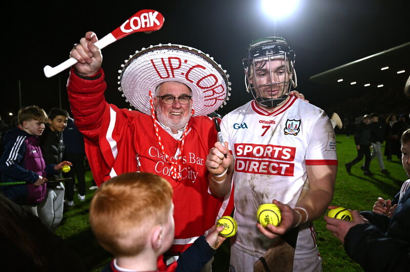 Cork supporter Cyril Kavanagh, left, celebrates as Mark Coleman signs autographs. Picture: Ben McShane/Sportsfile