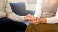 Caregiver women holding hands to elderly with alzheimer disease at home,Adult social care concept