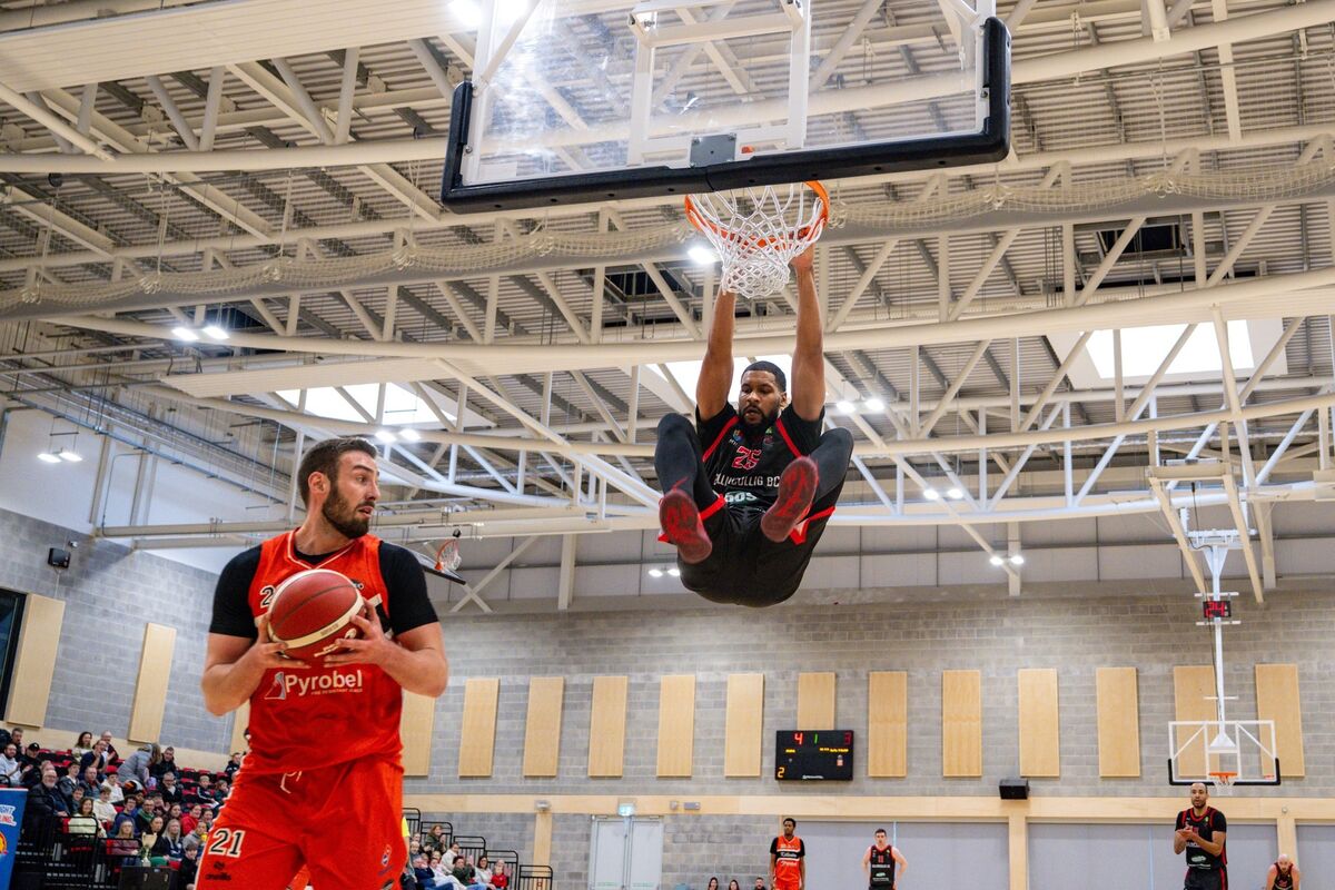 Ballincollig’s Latavious Mitchell hangs on the rim after finishing at the basket against Killester in the Domino Men’s Superleague at MTU Arena. Picture: Chani Anderson