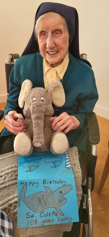 Sr Colette with Ellie the  Elephant who brought her a birthday card made by Patrick O'Donovan from Junior Infants at Barryroe National School.
