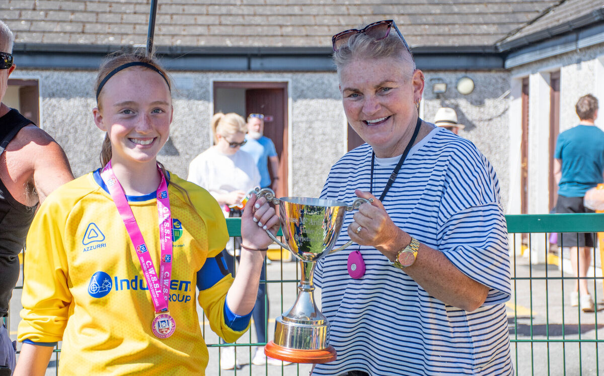 Carrigaline captain Faye Lerner receives the CWSSL U12 Cup from sponsor Denise McArdle Moore following her team's victory over Midleton in the final played in St Colman's Park. Picture: Howard Crowdy