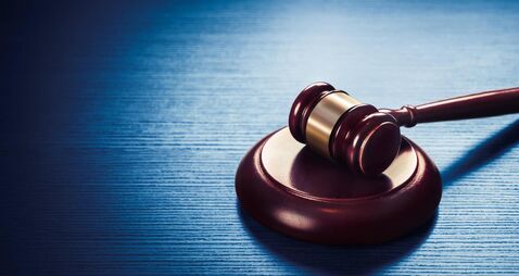 judge gavel on a blue wooden background