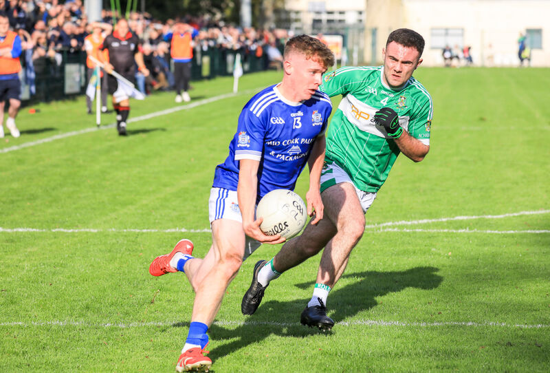 Naomh Abán's Daniel Kelly tries to get around Aghabullogue's Paul Dilworth. Picture: David Creedon