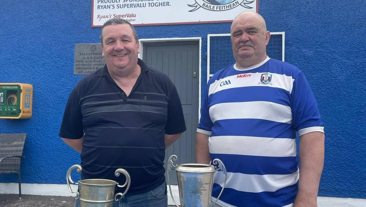 Ballyphehane GAA's Paul McCarthy and Timmy Walsh with the Confined JBFC trophy and the Terence McSwiney Cup trophy.