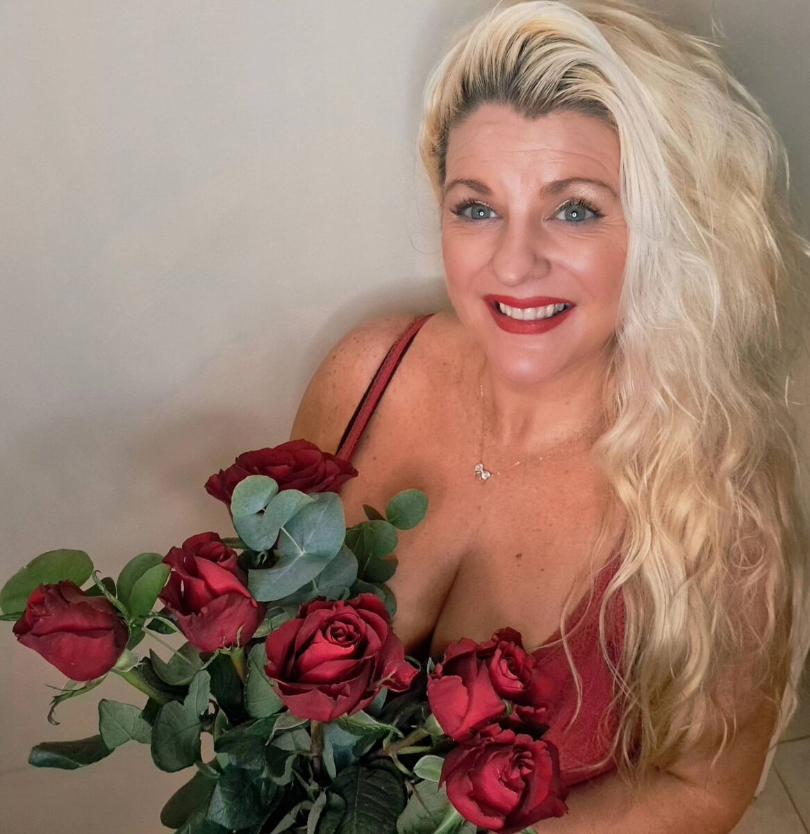 Emer O'Callaghan wearing a red dress from River Island with Valentine's Day Flowers. Tan is St Tropez and Emer's make-up is Master Colors Paris, available from Emerald Beauty Clinic, 021 4365949. Postage options available