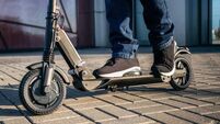 Close up view of legs of man on electric scooter