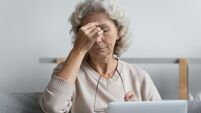 Mature pensioner tired of working at laptop from home