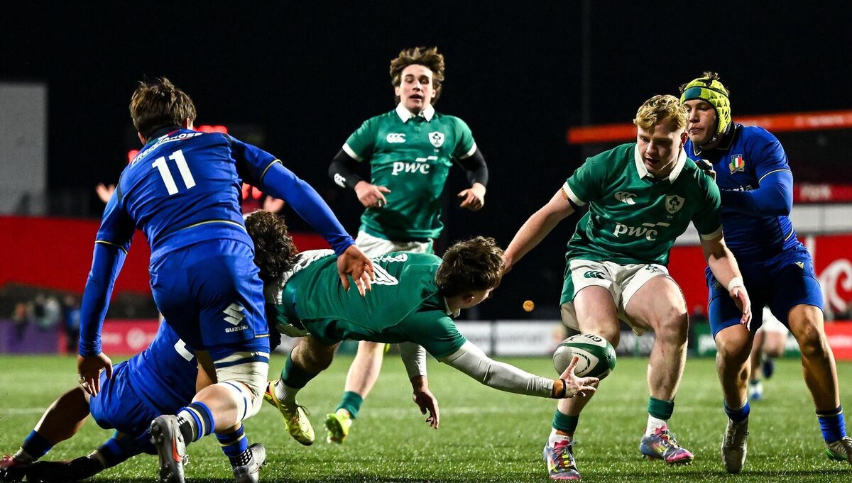Derry Moloney offloads the ball to team-mate Rob Carney despite the tackle of Nikolaj Varotto of Italy. Pic: Shauna Clinton/Sportsfile Derry Moloney offloads the ball to team-mate Rob Carney despite the tackle of Nikolaj Varotto of Italy. Pic: Shauna Clinton/Sportsfile