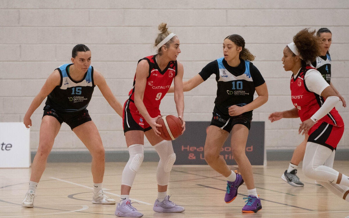 Grainne Dwyer of Catalyst Fr Matthew's about to pass the ball to Laila Blair. Picture: Howard Crowdy