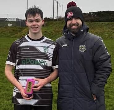 CBL secretary Peter Travers presents the man-of-the-match trophy to ePower East Cork goalscorer Joshua Dempsey following the Grandon’s Toyota Shield Group B encounter with Abbey Business at Mayfield Park last Saturday FB 
