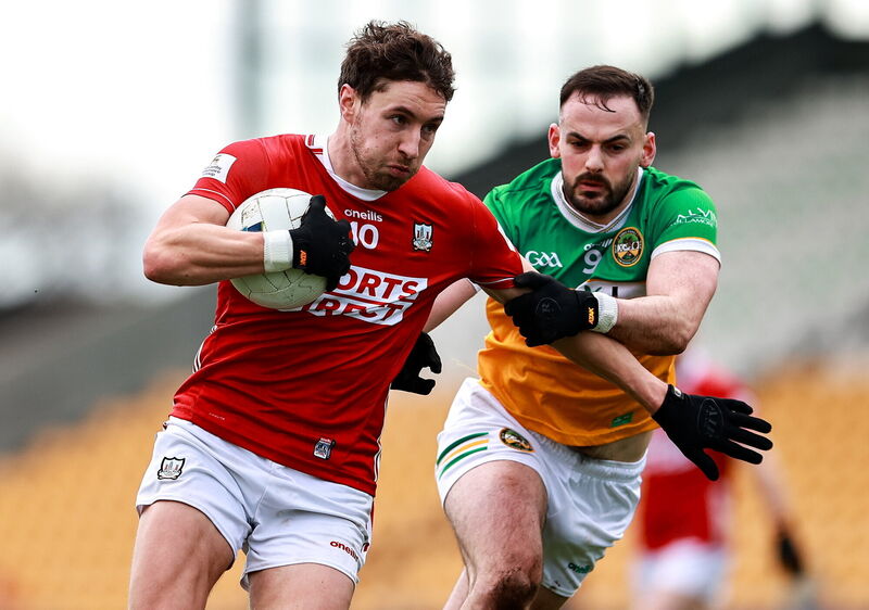 Paul Walsh of Cork in action against Aaron Leavy of Offaly. Picture: Thomas Flinkow/Sportsfile