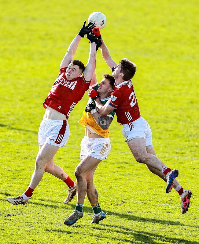 Cork players Luke Fahy and Ian Maguire in action against Jack McEvoy of Offaly. Picture: Thomas Flinkow/Sportsfile