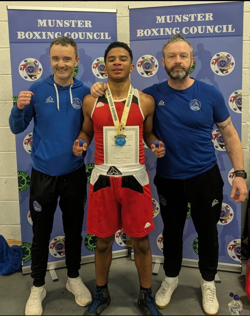 Cork Boxing: Togher coaches Philip Dwyer and Ian Power with Munster champion Peter Camara.
