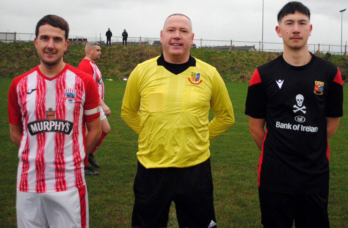 Castleview's captain Daniel O'Donoghue (left), with UCC A's Michael Daly, accompanied by referee Alan McDonagh.