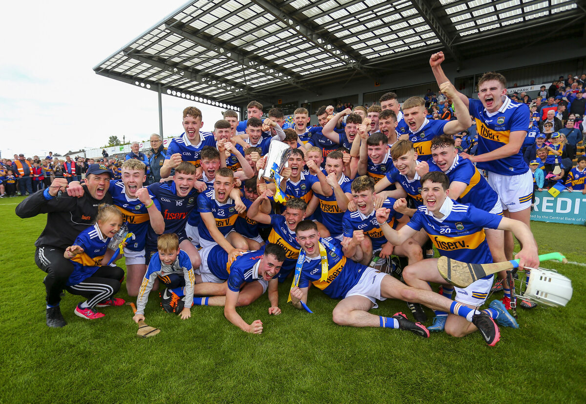 Tipperary players and manager James Woodlock celebrate with the trophy after beating Offaly in the 2022 Electric Ireland All-Ireland MHC final at packed UPMC Nowlan Park. Picture: Inpho/Ken Sutton=