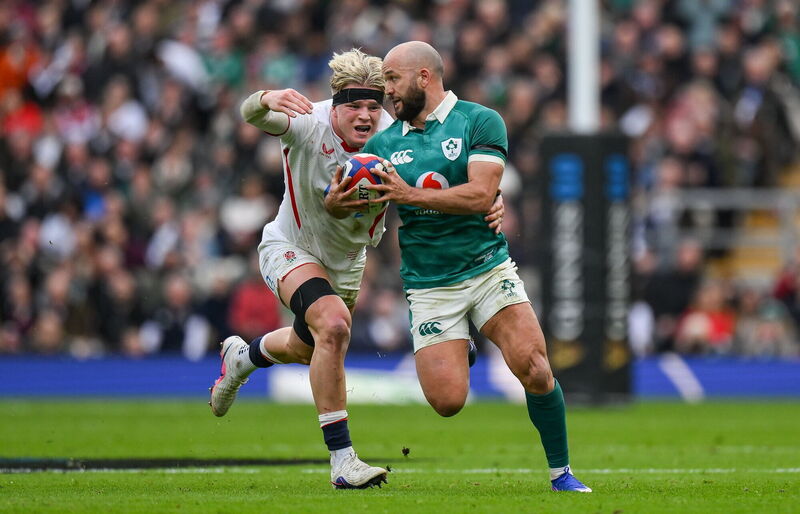 Jamison Gibson-Park of Ireland evades the tackle of England's Henry Pollock. Picture: Brendan Moran/Sportsfile