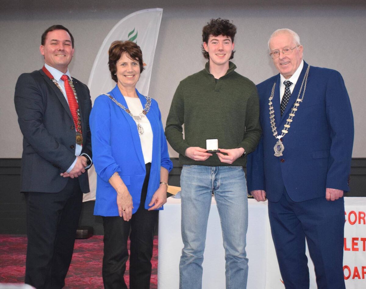 Finn Yore from the West Muskerry club receiving his international award. Also pictured are Michael Flynn, Chairperson Cork Athletics; Cllr Margaret McDonnell, Deputy Cork Lord Mayor; and Mossie Woulfe, President Munster Athletics. Picture: John Walshe 