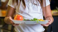 iStock-639407344.jpg Happy elementary school girl with healthy food in cafeteria