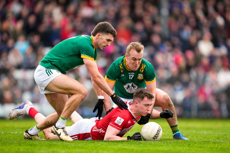 Luke Fahy of Cork is tackled by Ronan Ryan and Ciarán Caulfield of Meath. Picture: INPHO/James Lawlor