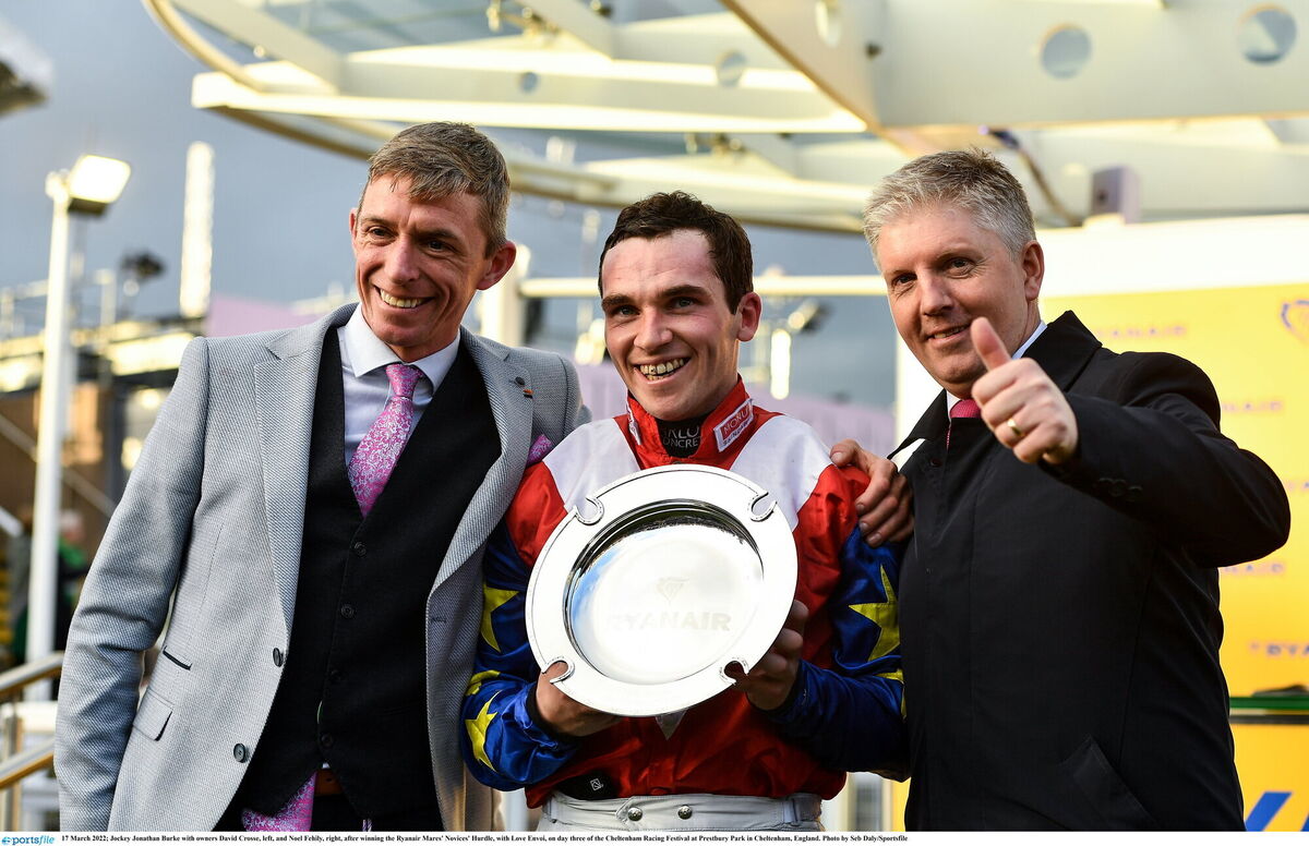 Jockey Jonathan Burke with owners David Crosse, left, and Noel Fehily, right, after winning the Ryanair Mares' Novices' Hurdle with Love Envoi in 2022. Picture: Seb Daly/Sportsfile