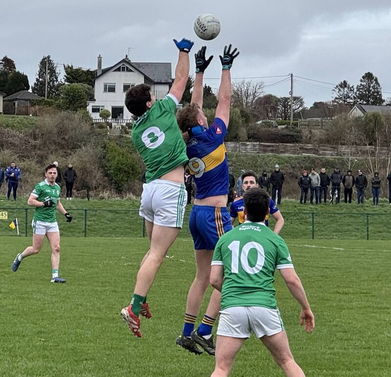 Ballincollig's Sean Dore and Carrigaline's Pa Mellett contest the high ball. Ballincollig's Sean Dore and Carrigaline's Pa Mellett contest the high ball.