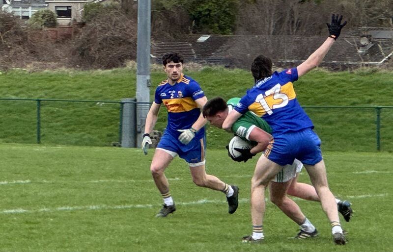 Carrigaline's Kevin O'Reilly tackles Ballincollig's Conor Dalton. Carrigaline's Kevin O'Reilly tackles Ballincollig's Conor Dalton.