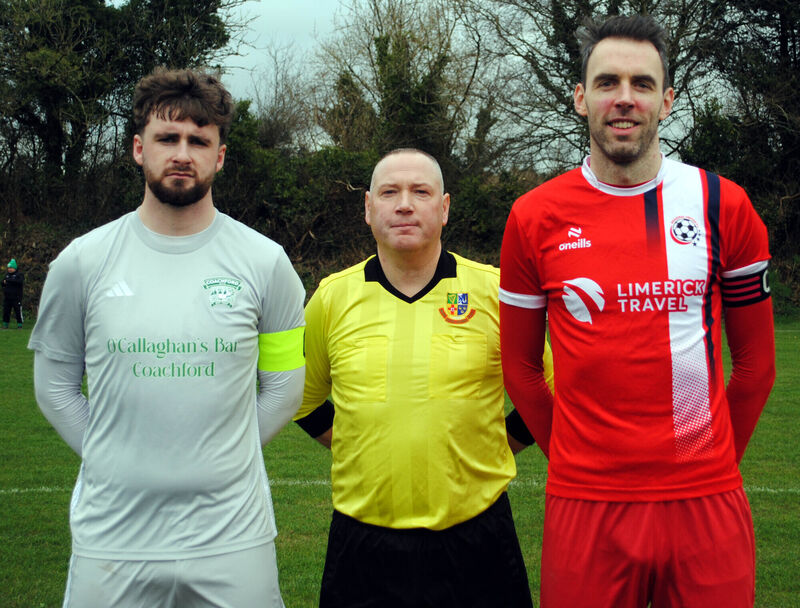 Coachford captain Mark Murphy (left), with Regency FC's Kiaran O'Connell, accompanied by referee Alan McDonagh. Picture: Barry Peelo.
