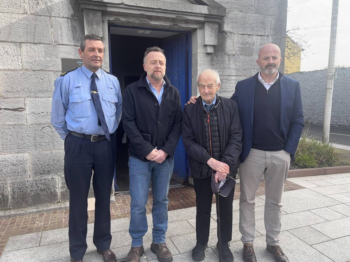 Garda Thomas Duane with Stephen O'Callaghan's brother Emmet, father John, and brother Keith after the inquest