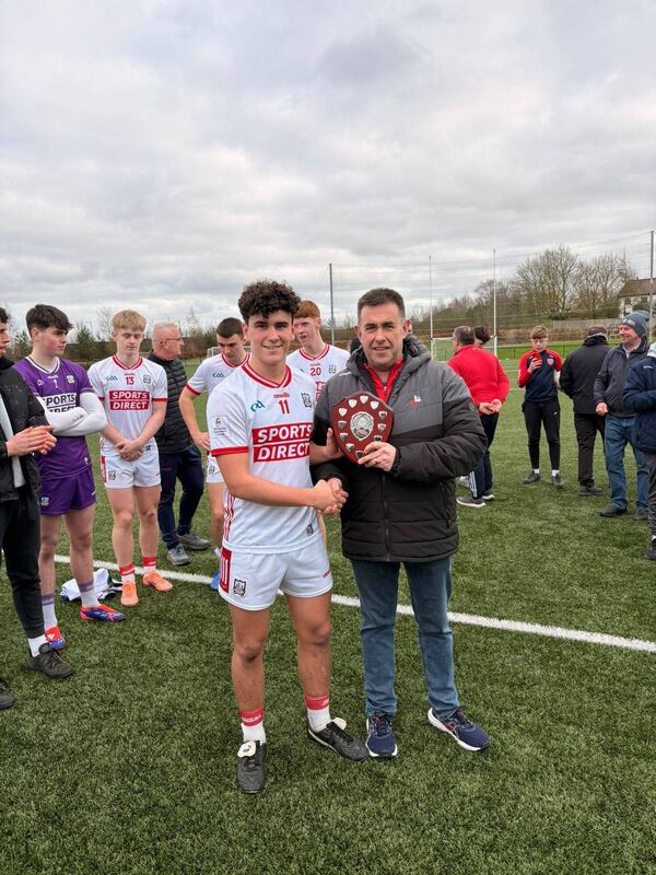 Cork captain Joe Miskella with the title after defeating Louth. Picture: Max Ricken