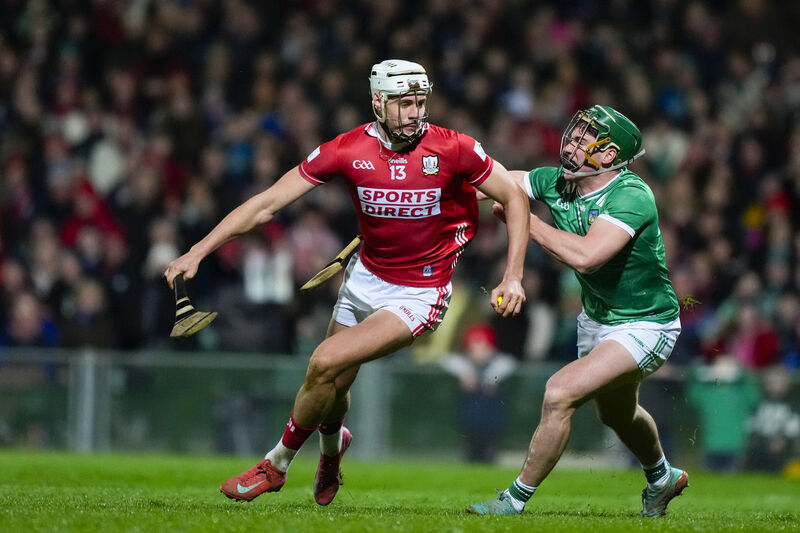 Cork's Alan Walsh in possession, shadowed by Limerick's Seán Finn. Picture: Inpho/James Lawlor